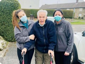 Avanti care workers assisting a gentleman on a shopping trip